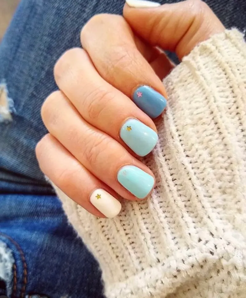 Light blue nails with a gold star