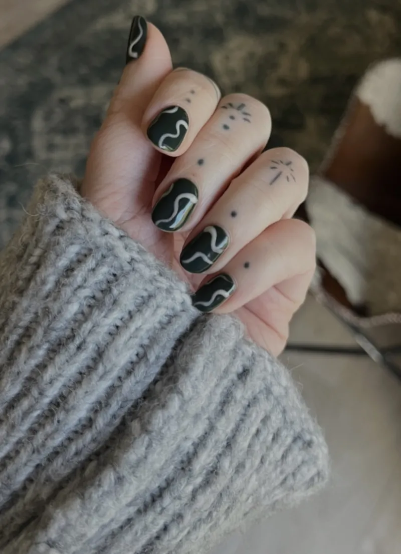 Dark green nails with light grey stripes