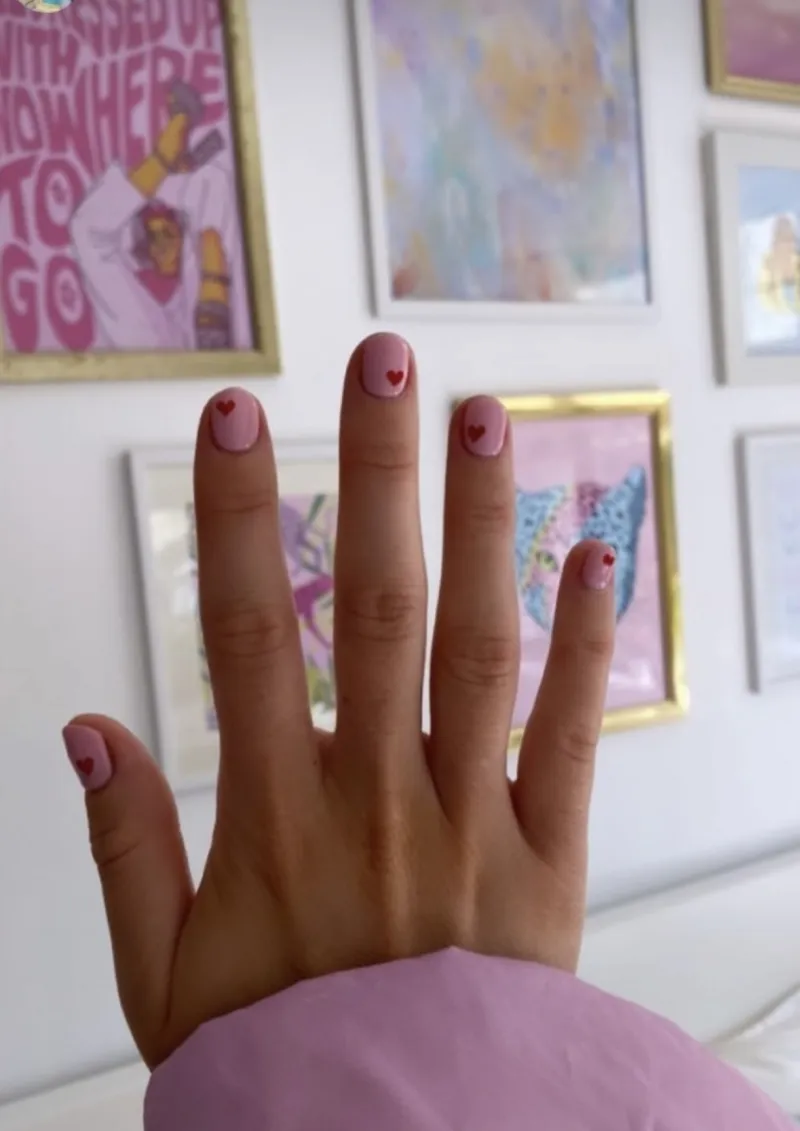 Light pink nails with red hearts